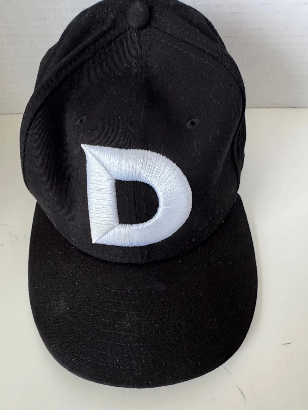 Black Baseball Cap with White 'D' Embroidered Patch